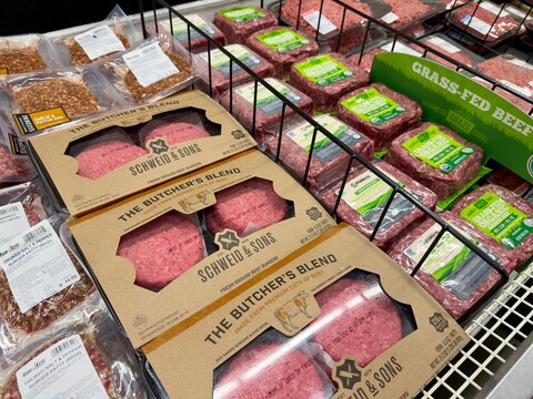 packages of ground beef for sale at a supermarket shelf