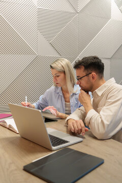 Two colleagues collaborating on a project while working together in modern office