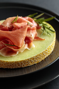 Italian prosciutto with melon and fresh rosemary.