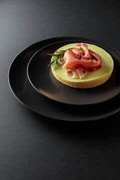 Italian prosciutto with melon and fresh rosemary.