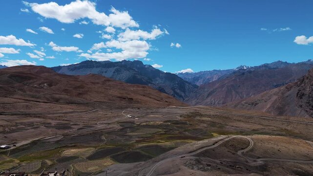 Stunning Aerial Drone View of Langza Village in Spiti Valley, Himachal Pradesh with Tourists Visiting the Iconic Maitreya Buddha Statue Amid Rugged Cold Desert Mountains