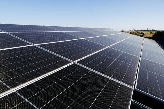 Solar panels covering a rooftop and converting sunlight into electricity. Concept clean power generation, renewable technology and sustainable energy solutions.