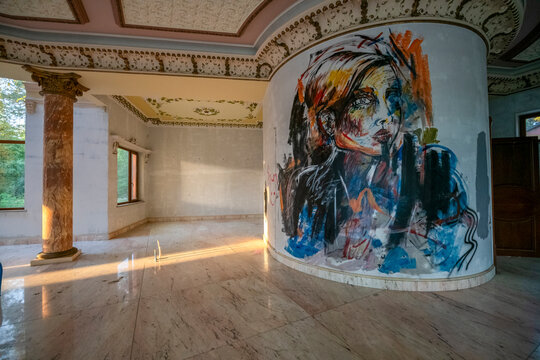 Abandoned luxury mansion interior with marble hall, ornate fireplace, swimming pool and glass facade