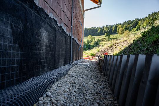 Waterproofing membrane applied to the foundation wall of a house under construction