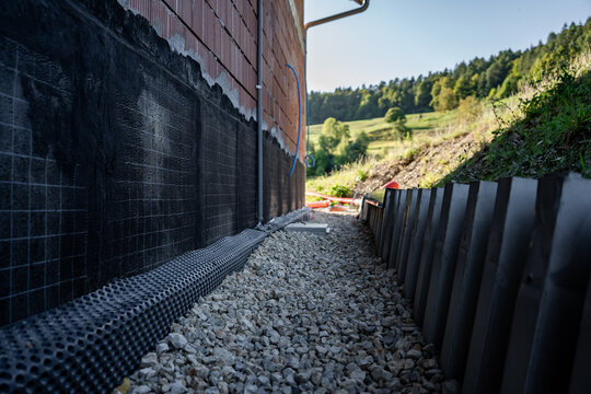 Waterproofing membrane applied to the foundation wall of a house under construction