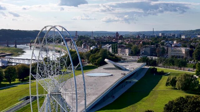 Aerial drone footage of a Ferris wheel under construction on Nemunas Island in Kaunas, Lithuania, showing a new observation attraction rising in the city center. 4K video 