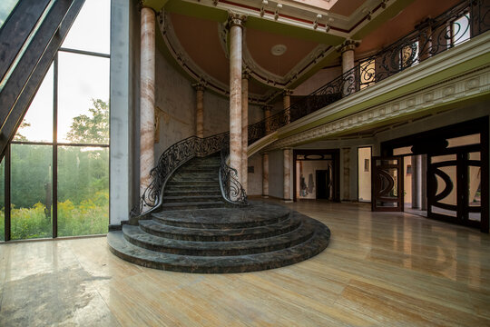 Abandoned luxury mansion interior with marble hall, ornate fireplace, swimming pool and glass facade