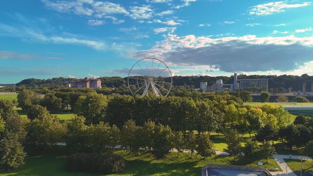 Aerial drone view of Science Island Museum and Ferris wheel on Nemunas Island in Kaunas, Lithuania, showcasing modern architecture and a new city attraction