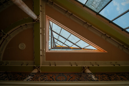 Abandoned luxury mansion interior with marble hall, ornate fireplace, swimming pool and glass facade