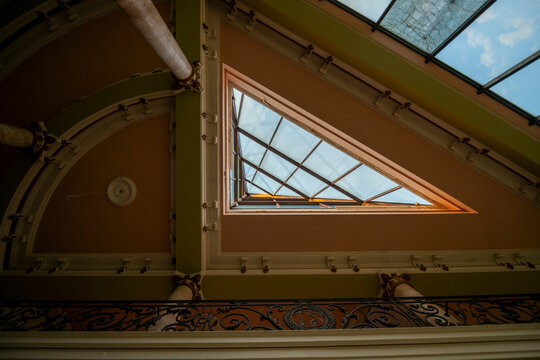 Abandoned luxury mansion interior with marble hall, ornate fireplace, swimming pool and glass facade