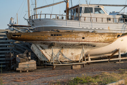 Traditional wooden fishing boat in a Grado boatyard, showing weathered hull details and maritime heritage near the Grado Lagoon in Friuli Venezia Giulia, Italy.