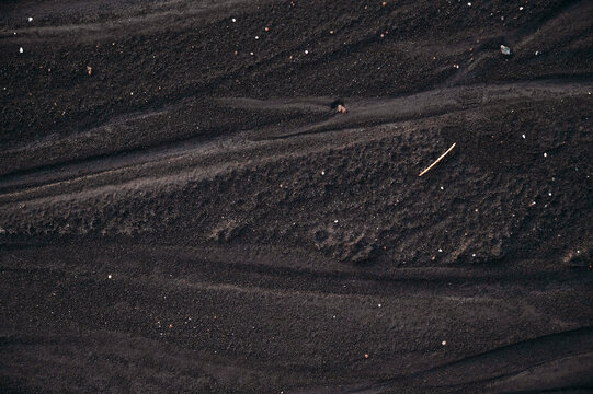 Abstract Black Volcanic Sand Texture with Natural Flow Patterns