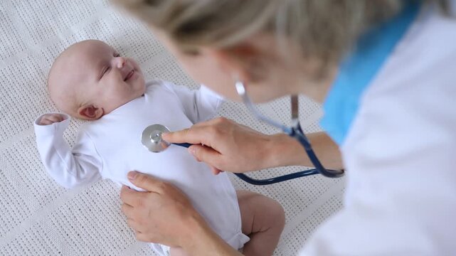 Medical worker checks newborn baby with stethoscope, while baby lies calm in white outfit and adult hands steady chest examination during gentle medical checkup, listening to heart and breathing.