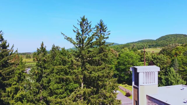 Quebec, Canada - September 12: A sweeping 4K aerial drone video over a vast, thriving apple orchard in Quebec, featuring rows of trees laden with red fruit, winding farm paths, and a rustic barn under