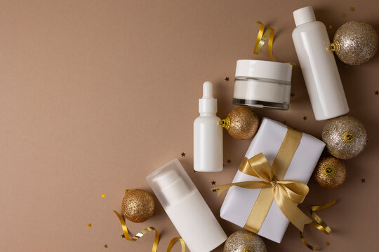 Luxury skincare gift set with Christmas decorations on color background 