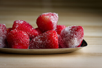Frozen strawberries chilling on plate ready for dessert © Gabriel