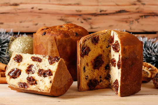 Sliced ​​special Christmas panettone with chocolate filling on a handcrafted wooden table.