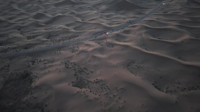 Aerial View of Desert Road with Convoy in Tengger Desert