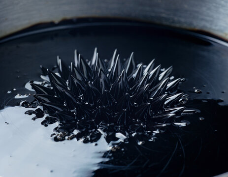 Macro Ferrofluid Magnetic Spikes on Dark Background