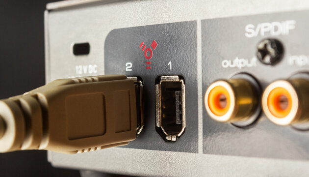 Photo of a firewire sound board input connector sockets on black background.