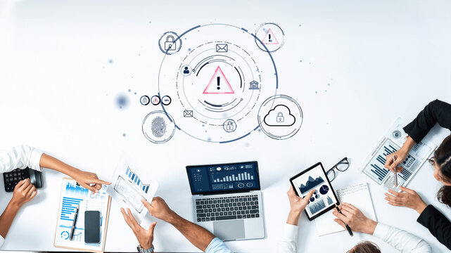 Business Team Collaborating on Data Analysis with Digital Devices, Security Symbols and Warning Signs on Workspace Table. Entropy.