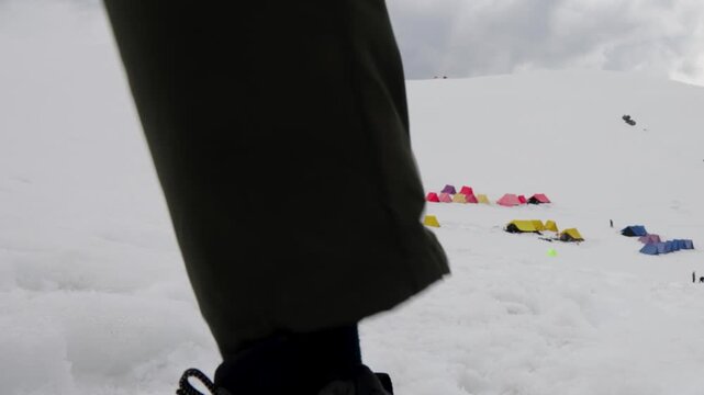Adventure Trekker Walking Through Snow at a Scenic Himalayan Base Camp