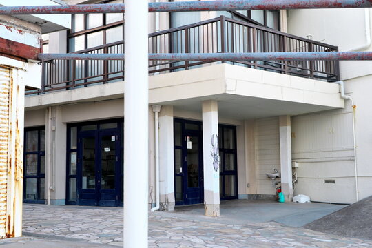 Japan urban building entrance with balcony and paving