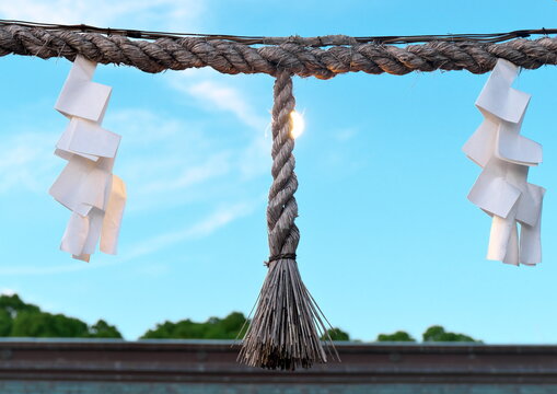 Shimenawa straw rope and shide paper streamers at Japanese shrine