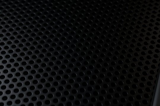  Perforated black metal sheet texture with regular round holes pattern in diagonal perspective. 3D render.