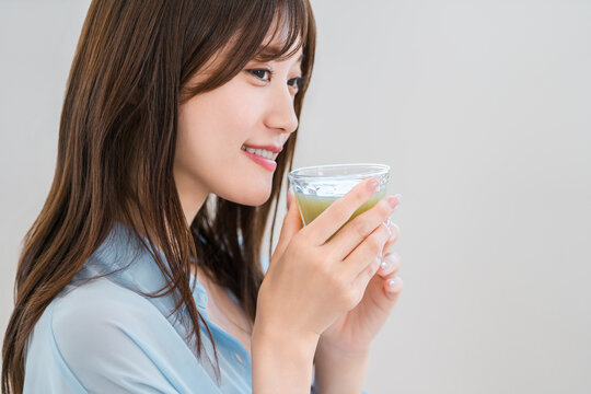 Young Woman Enjoying a Nutritious Green Smoothie, Healthy Morning Routine for Beauty and Wellness
