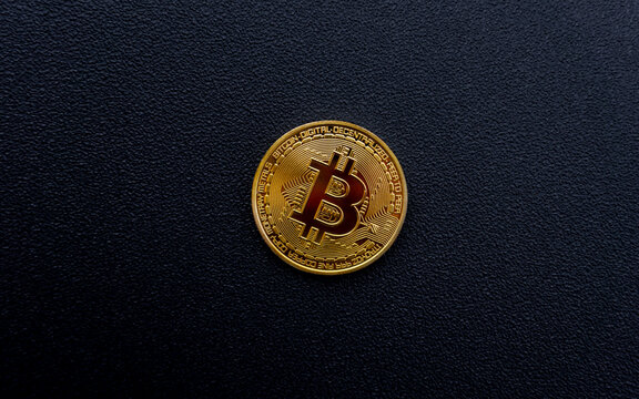 Golden Bitcoin Coin On Minimal Black Background Surface