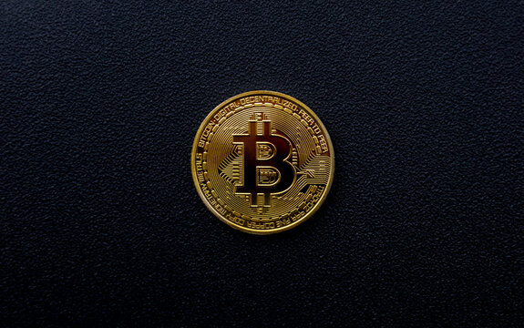 Golden Bitcoin Coin On Minimal Black Background Surface