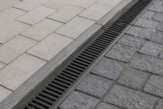 Modern Driveway Drainage Channel Neatly Integrated Between Clean Paving Surfaces In Professional Real Estate Photo