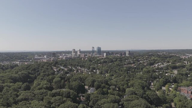 Aerial Reveal of White Plains Neighborhood and Distant City Skylin