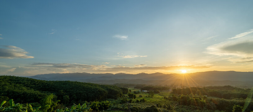 landscape view of green mountain at sunset sky background.