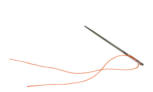 A sharp silver sewing needle with a vibrant orange thread trailing behind isolated on a clean white background for textile craft projects