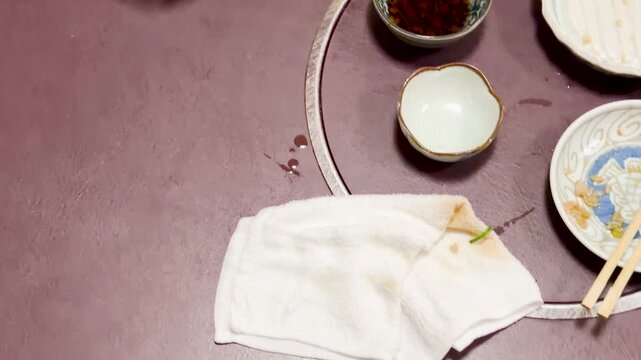 Camera panning across empty plates and traditional japanese tableware after dinner at restaurant.