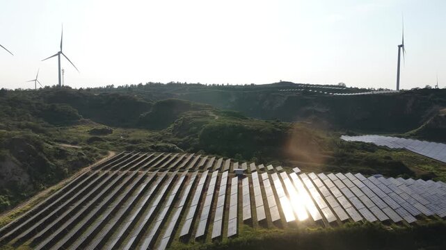 Rows of solar panels on a green hillside