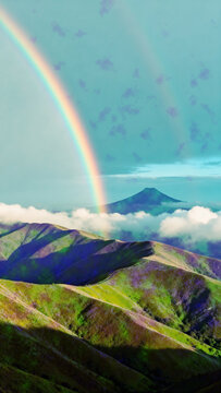 Green hills and mountain under clear sky