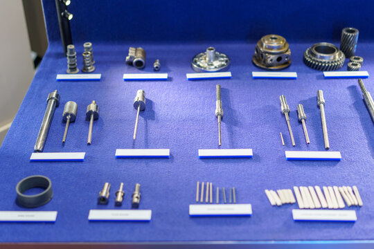 Machined metal gears and precision parts on blue display