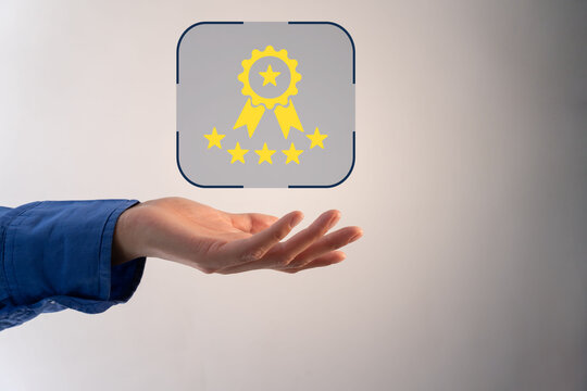 Hand presents a glowing award badge with stars