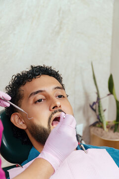 Man receiving dental examination at clinic for oral hygiene