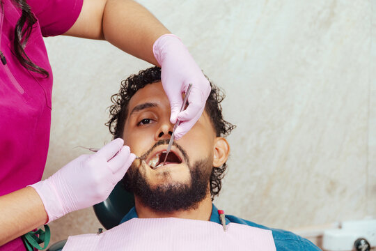 Adult male receiving dental examination in clinic