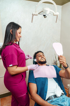Dentist examining patient's healthy teeth during dental appointment