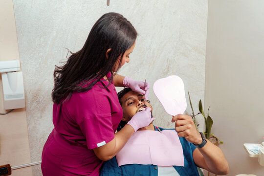 Dentist examining patient's teeth during oral checkup