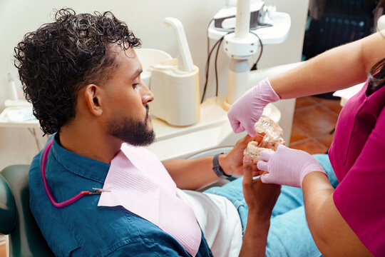 Patient receiving dental health education in clinic