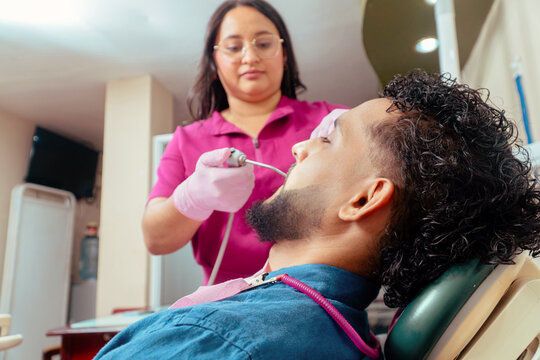 Dentist examining patient during dental health care treatment