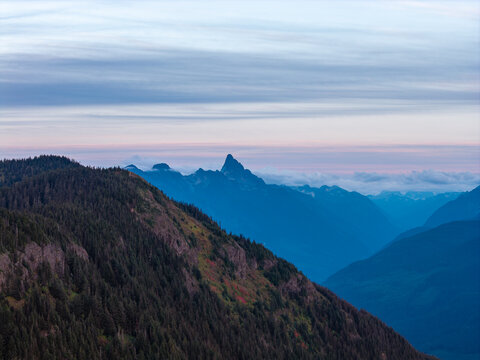 Elk Mountain Ridge At Sunrise Over Chilliwack BC Canada With Layered Blue Mountain Peaks