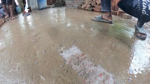 Construction Worker Chipping Concrete Surface Using Hoe Tool on Site