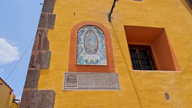 Nuestra Senora De Guadalupe Tile Mosaic And Plaque On Yellow Church Facade